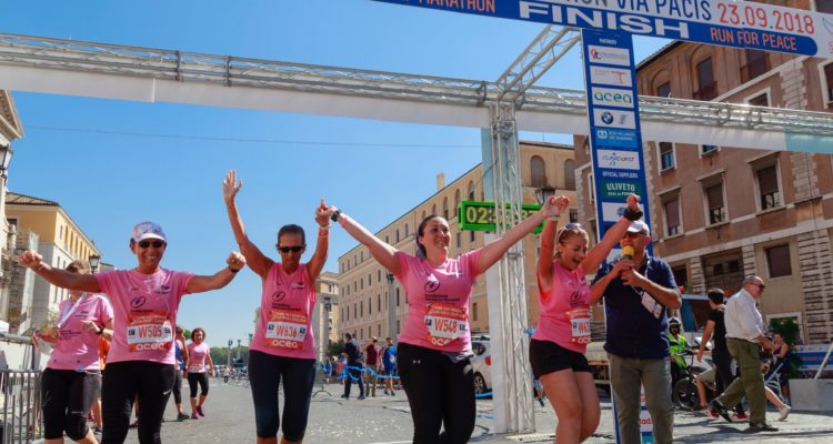 fundraisers running across a finish line