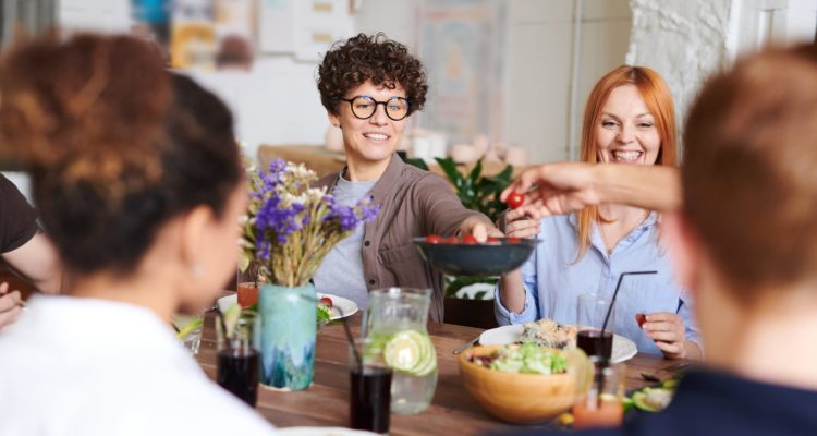 Group of people sharing a pot of tea