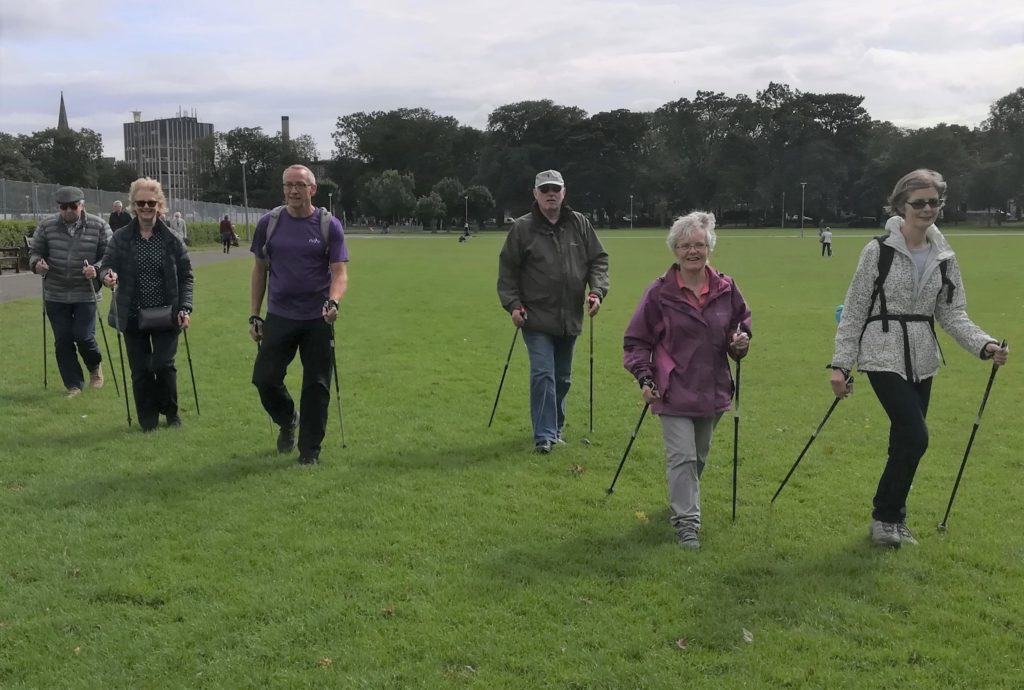 nordic walking group out in the meadows